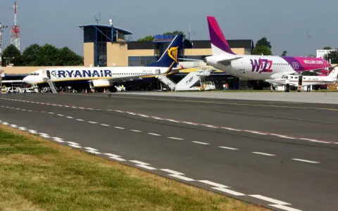 Dwa samoloty, Ryanair i Wizz Air, stojące na płycie lotniska.