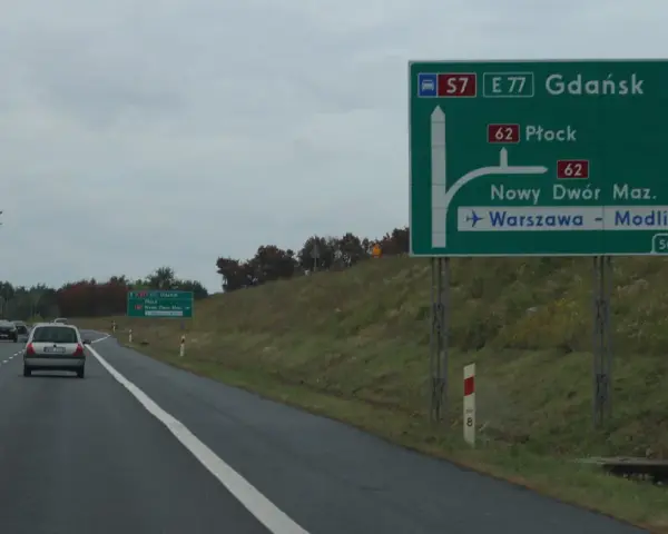 Zielony znak drogowy z kierunkami: Gdańsk, Płock, Nowy Dwór Maz., Warszawa-Modlin.